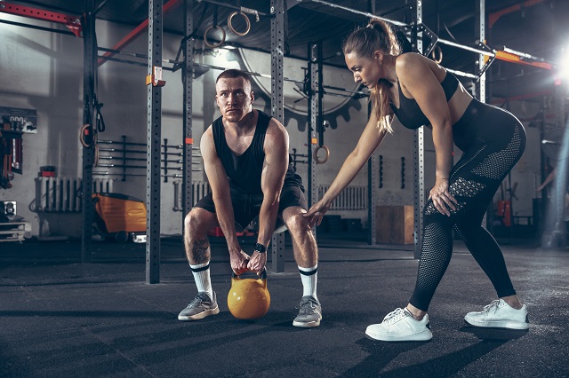 Athletic man and woman with a dumbbells