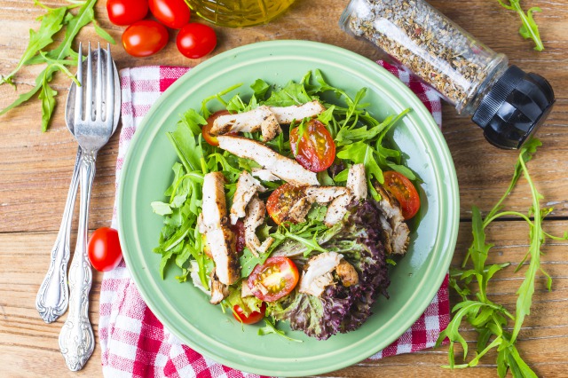 fresh-salad-with-chicken-breast-arugula-and-tomato-top-view